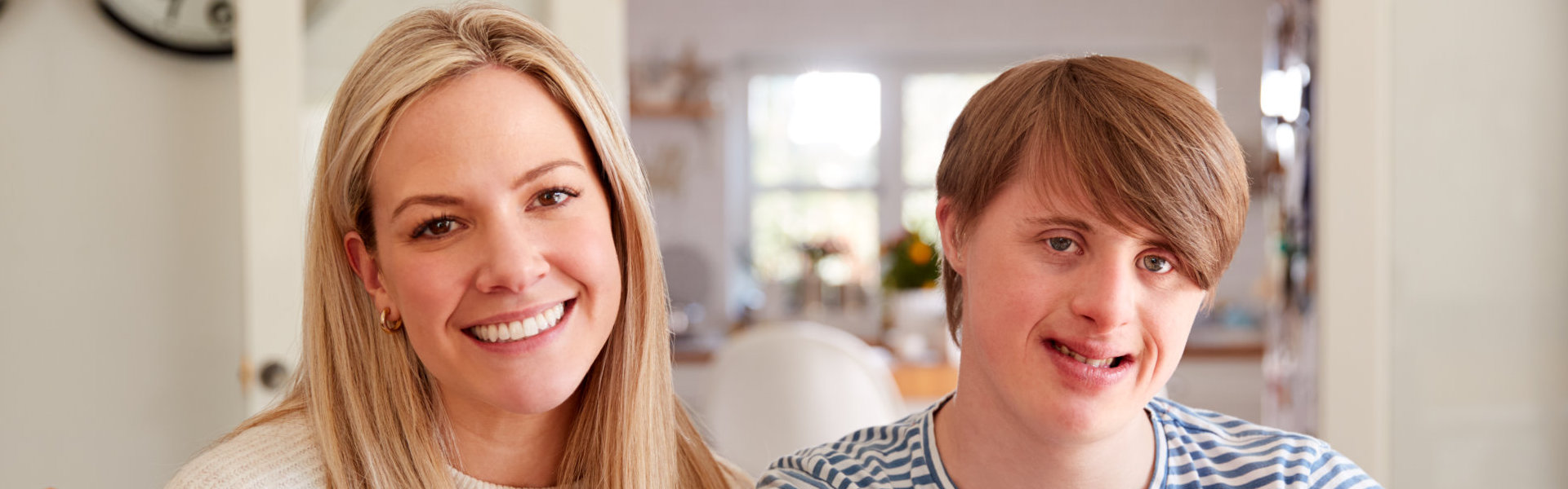 Woman with young boy smiling while looking at the camera