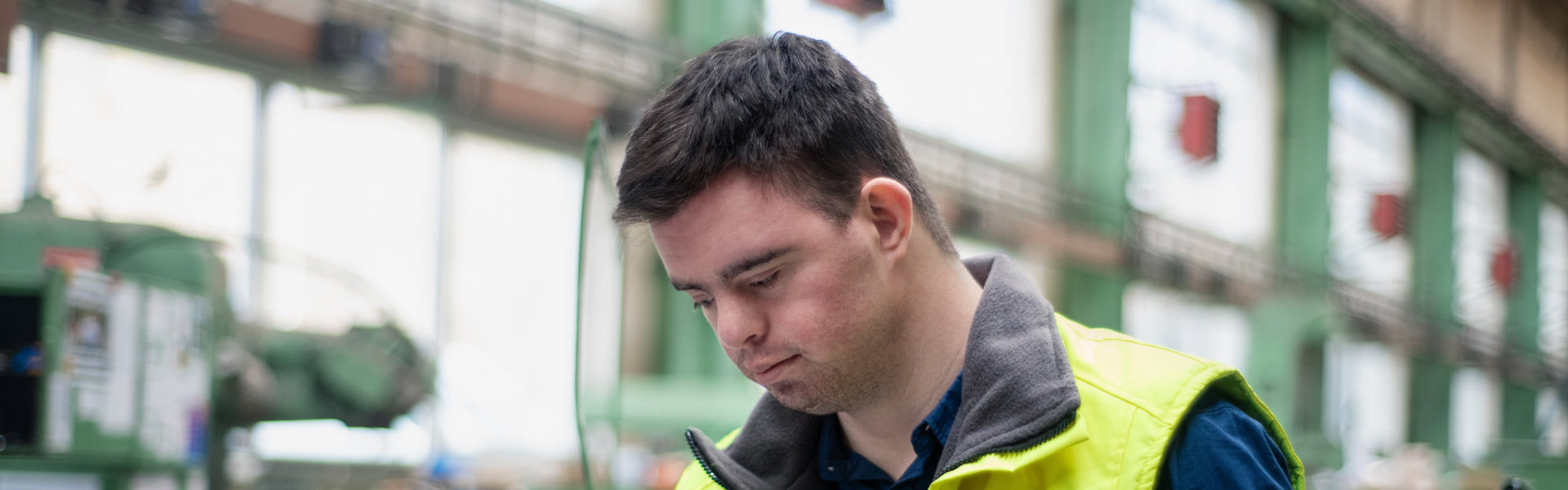 Man with special needs inside a factory facility