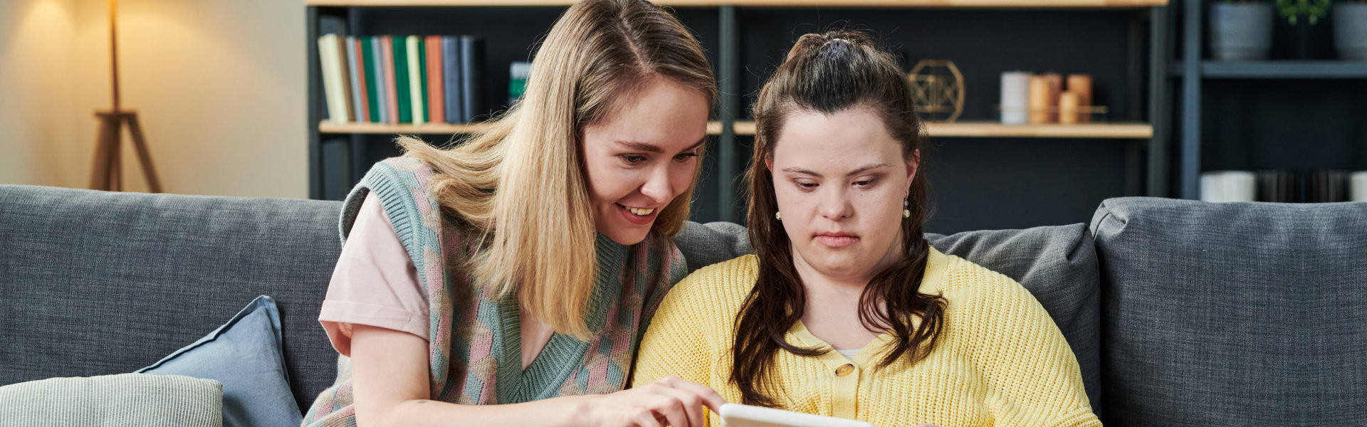 Woman teaching the child with special needs using tablet